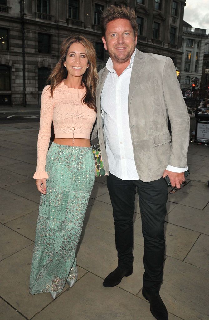 James Martin with his partner Louise wearing a pink crop top and blue skirt
