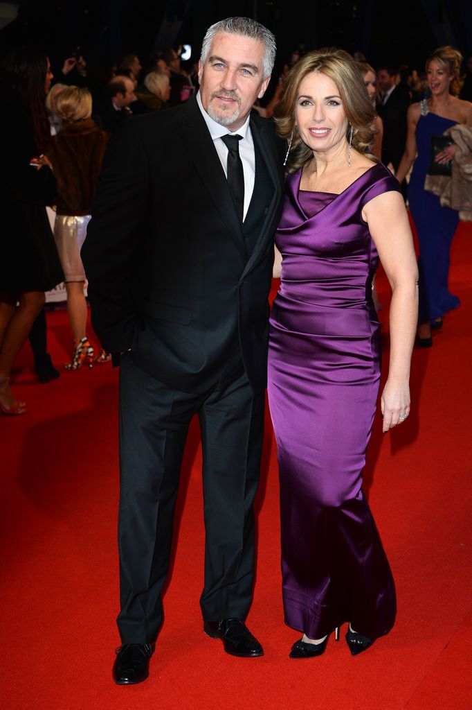 Paul Hollywood in a black suit and Alex Hollywood in a purple dress