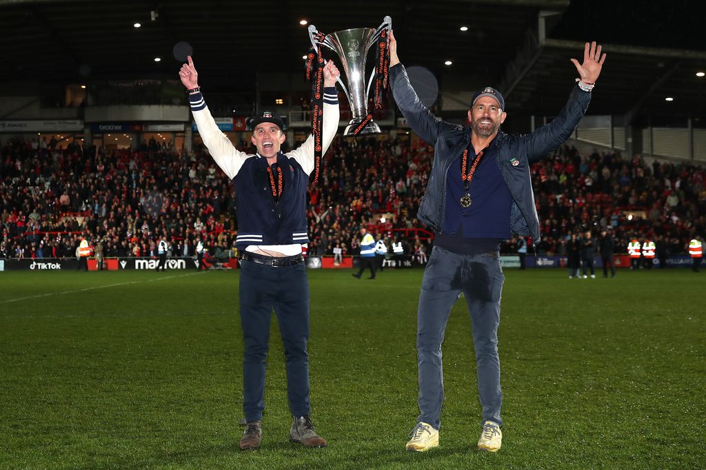 Rob McElhenney and Ryan Reynolds, Owners of Wrexham celebrate with the Vanarama National League trophy as Wrexham win the Vanarama National League and are promoted to the English Football League after victory in the Vanarama National League match between 