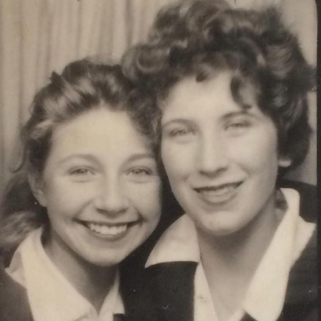 A young Zoe Ball with curly hair next to her mother