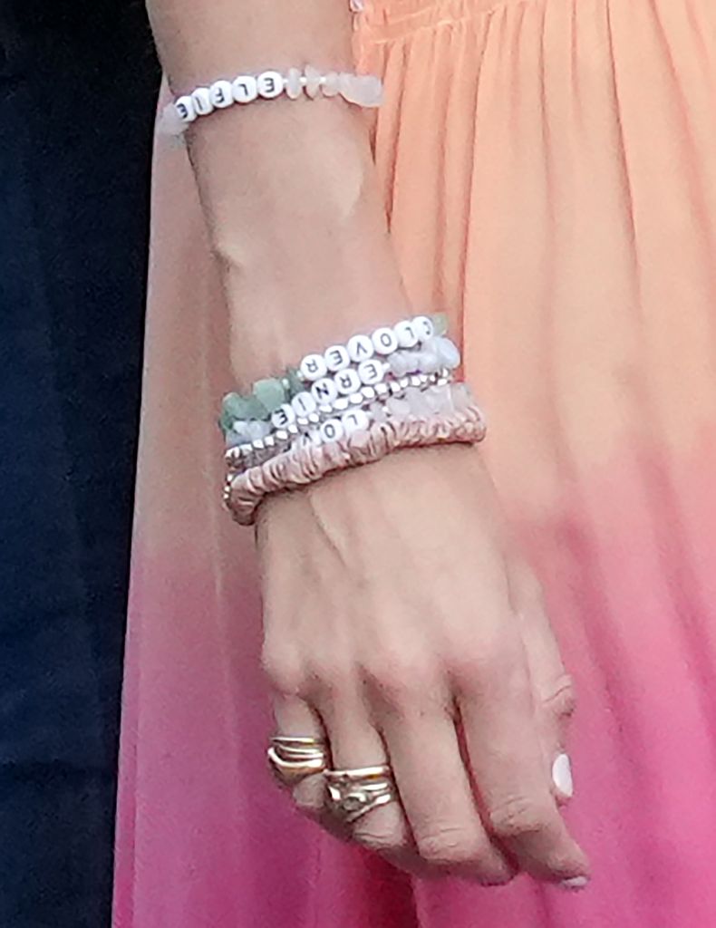 Daisy Jenks wears bracelets bearing her children's names as she leaves for the evening party for the wedding of The Duke of Westminster to Olivia Henson