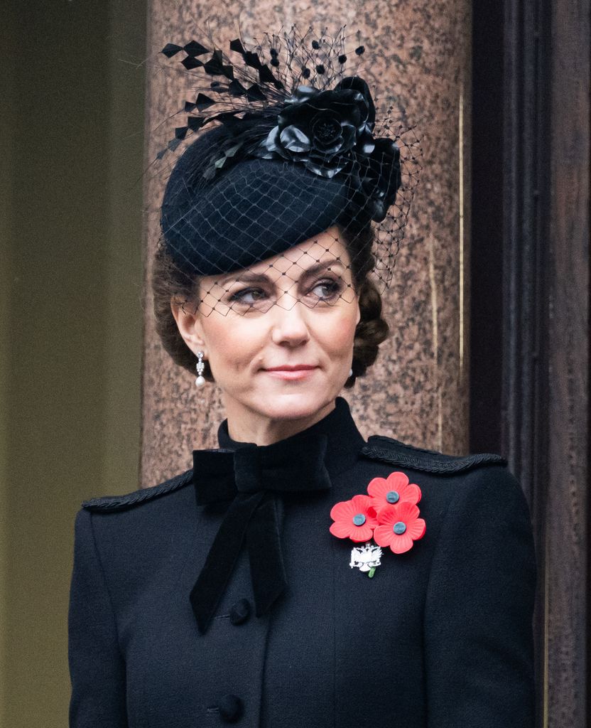 Princess of Wales (Kate Middleton) wears a black fascinator with netting, adorned with red poppies. Her poised expression and attire are reminiscent of traditional British elegance.