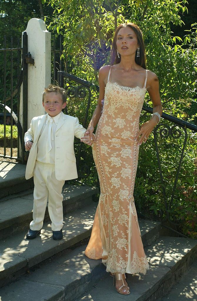 Victoria Beckham with her son Brooklyn in lace dress