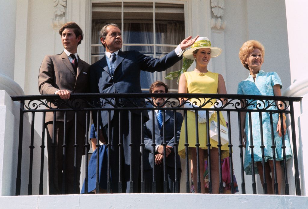 Princess Anne in a yellow mini dress on a balcony