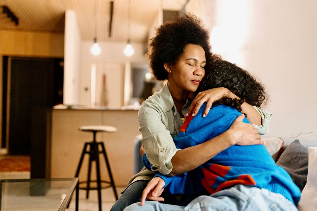 Mother and son hugging at home