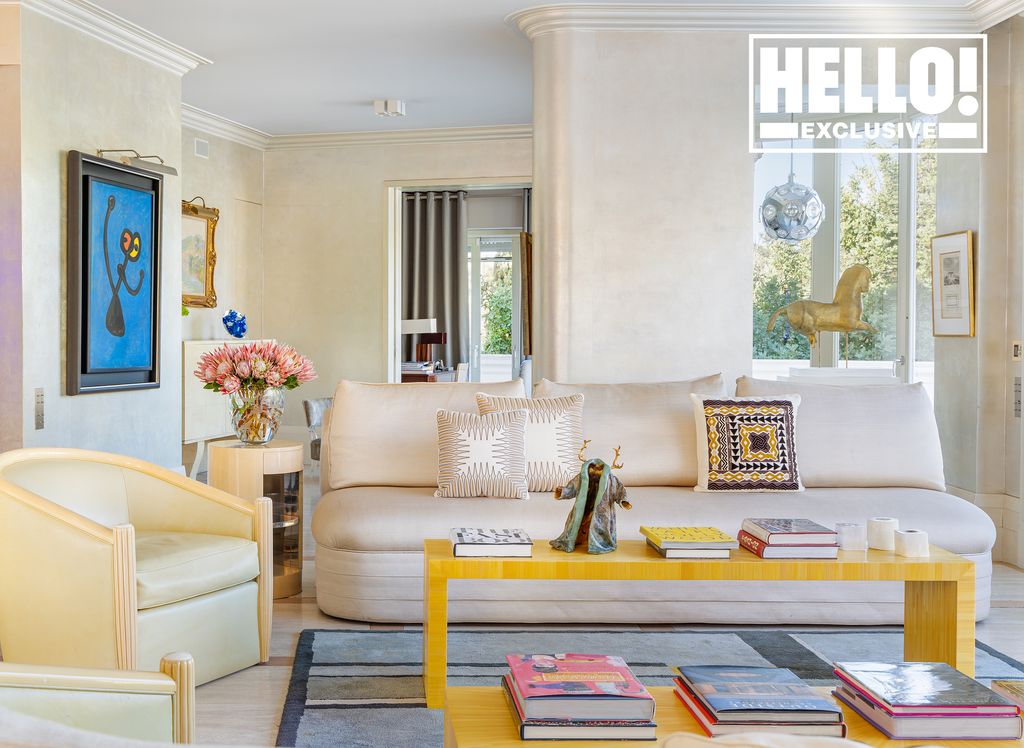 Celia Kritharioti home cream sofa with blue artwork and yellow coffee table