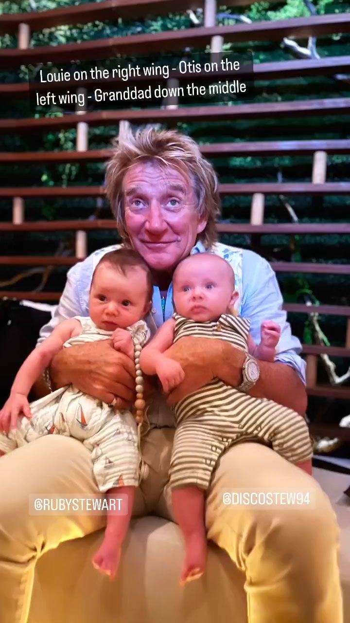rod stewart holding grandsons on knees 