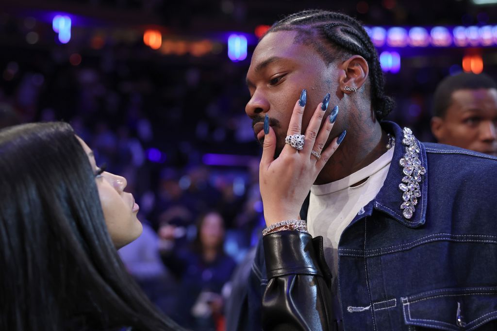 photo of cardi b with her hand on stefon diggs face