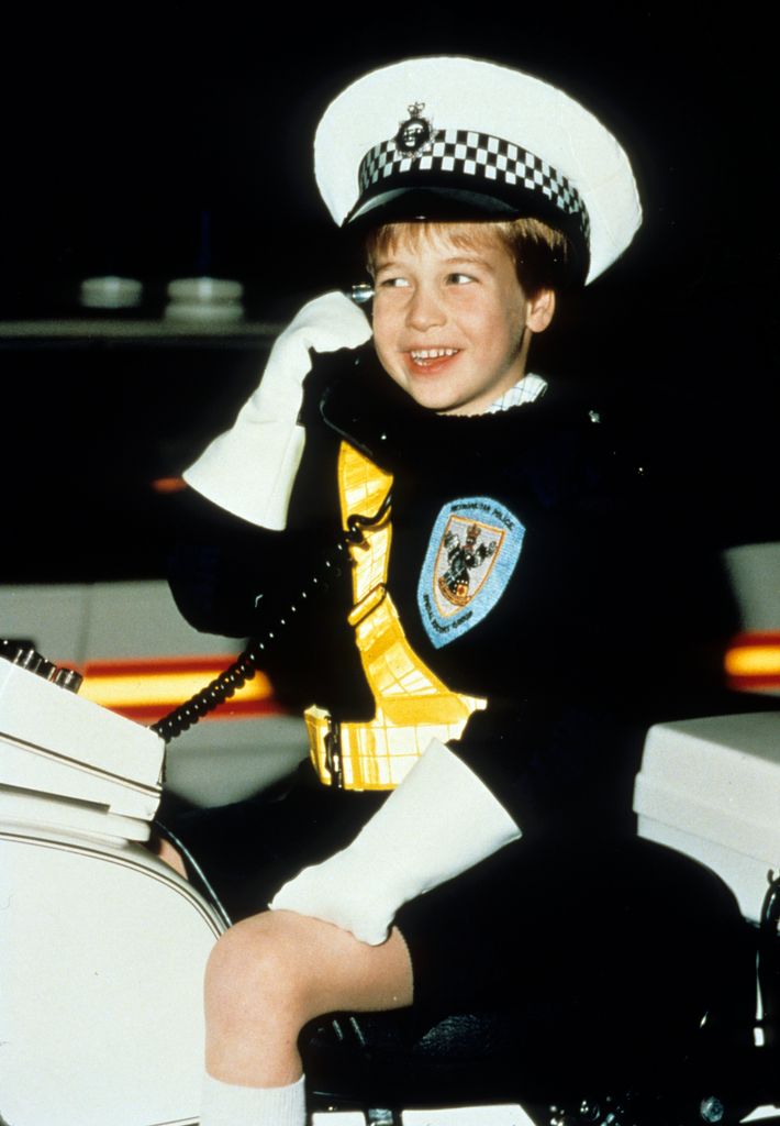 Prince William wears a policeman's uniform as he sits on a police motorbike during a visit to the Windsor police in November 1987