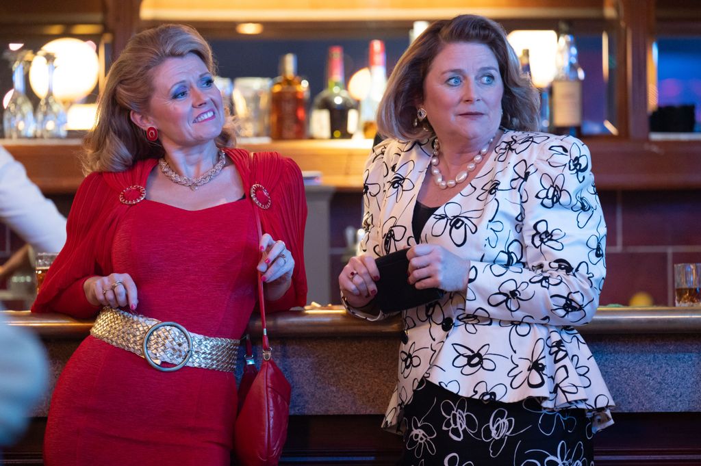 two women standing by bar