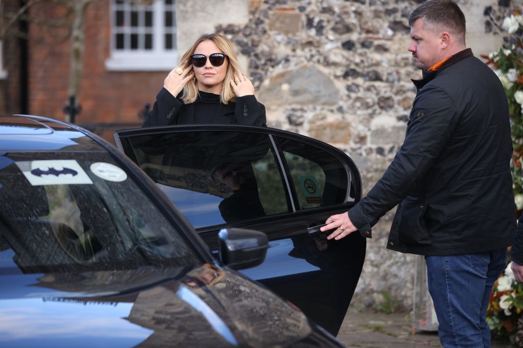 Kimberley Walsh exiting a car with a Batman sticker on the windscreen