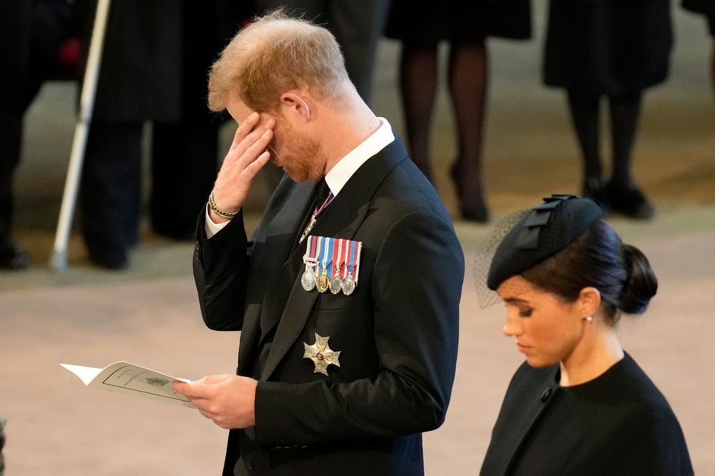 An emotional Prince Harry and Meghan pay their respects in The Palace of Westminster after the procession for the Lying-in State of Queen Elizabeth II on September 14, 2022 