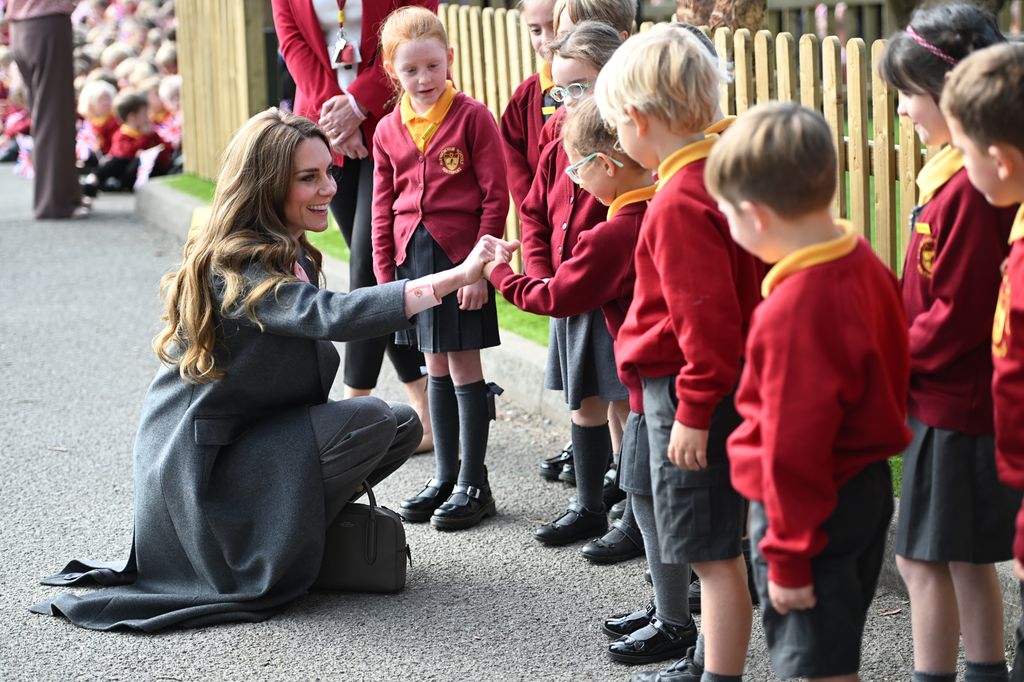 Kate holds hand of schoolgirl in Southport