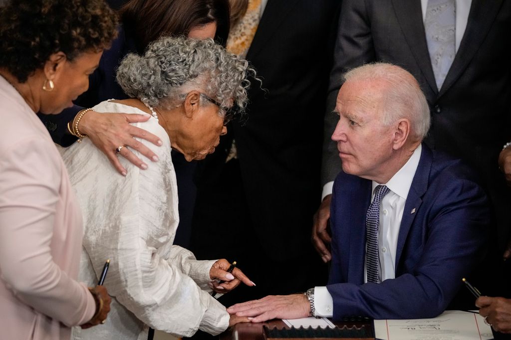 WASHINGTON, DC - JUNE 17: (L-R)  Ninety-four-year-old activist and retired educator Opal Lee, known as the Grandmother of Juneteenth, speaks with U.S. President Joe Biden after he signed the Juneteenth National Independence Day Act into law in the East Room of the White House on June 17, 2021 in Washington, DC. The Juneteenth holiday marks the end of slavery in the United States and the Juneteenth National Independence Day will become the 12th legal federal holiday â the first new one since Martin Luther King Jr. Day was signed into law in 1983. (Photo by Drew Angerer/Getty Images)