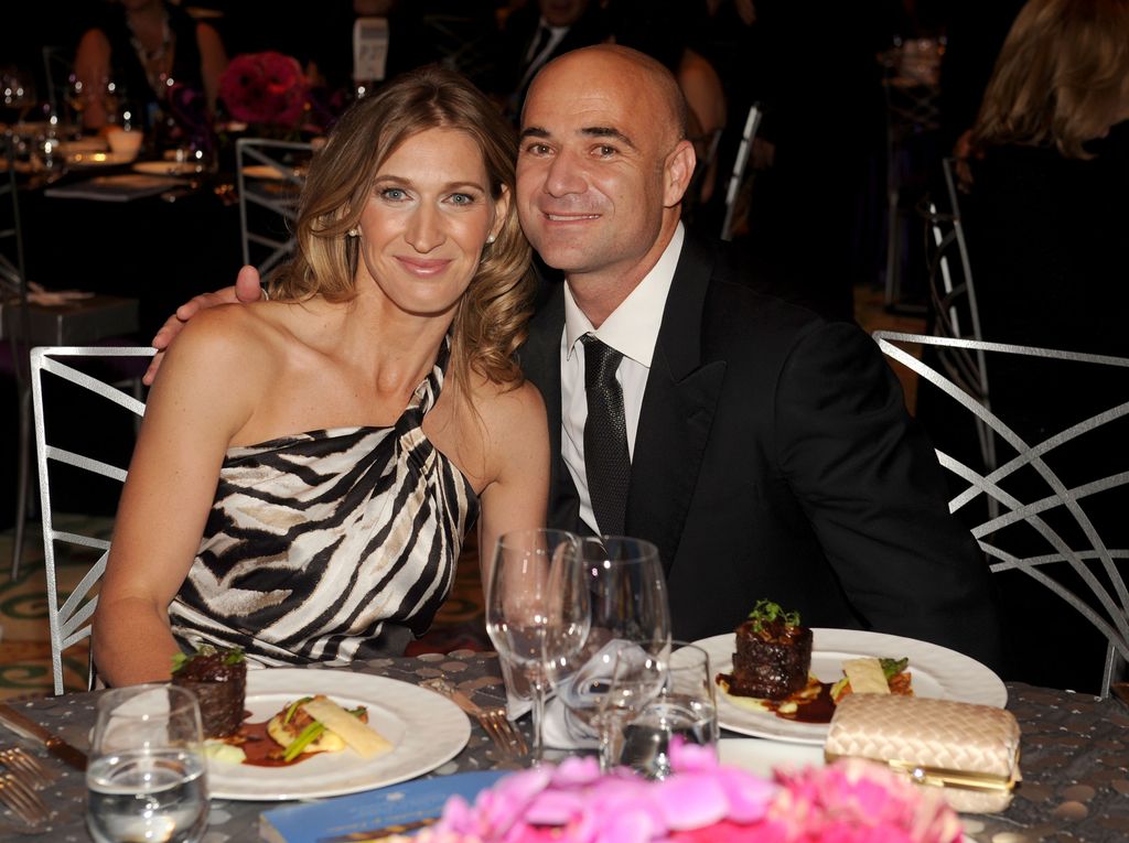 Andre Agassi in a suit and Stefanie in a one-shoulder dress at dinner
