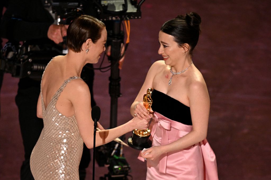 US actress Mikey Madison accepts the award for Best Actress in a Leading Role for "Anora" from US actress Emma Stone onstage during the 97th Annual Academy Awards at the Dolby Theatre in Hollywood, California on March 2, 2025.