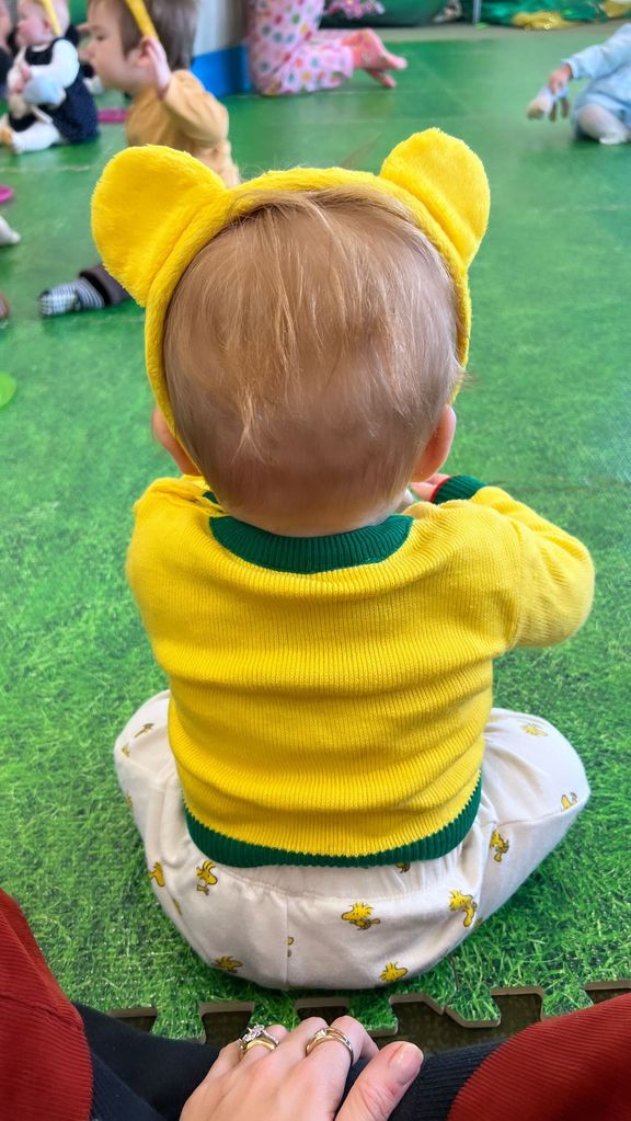 A photo of baby Frank wearing yellow bear ears 