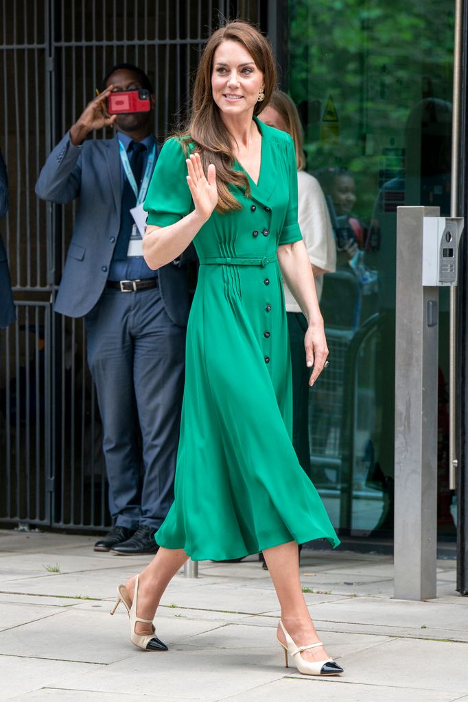 Catherine in green dress waving