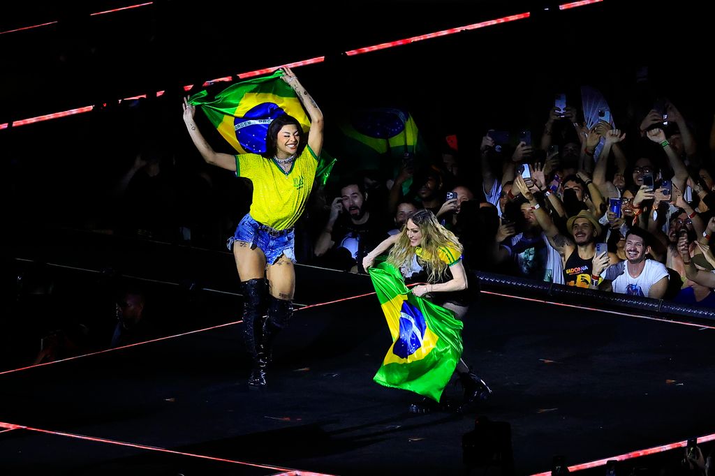 Madonna and Brazilian singer Pabllo Vittar show Brazilian flags on stage during a massive free show to close "The Celebration Tour" at Copacabana Beach on May 04, 2024 in Rio de Janeiro, Brazil.
