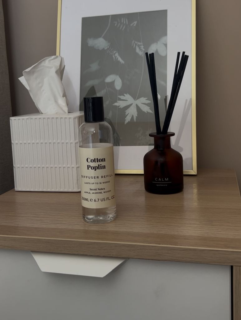 reed diffuser, tissues, photoframe on bedside cabinet