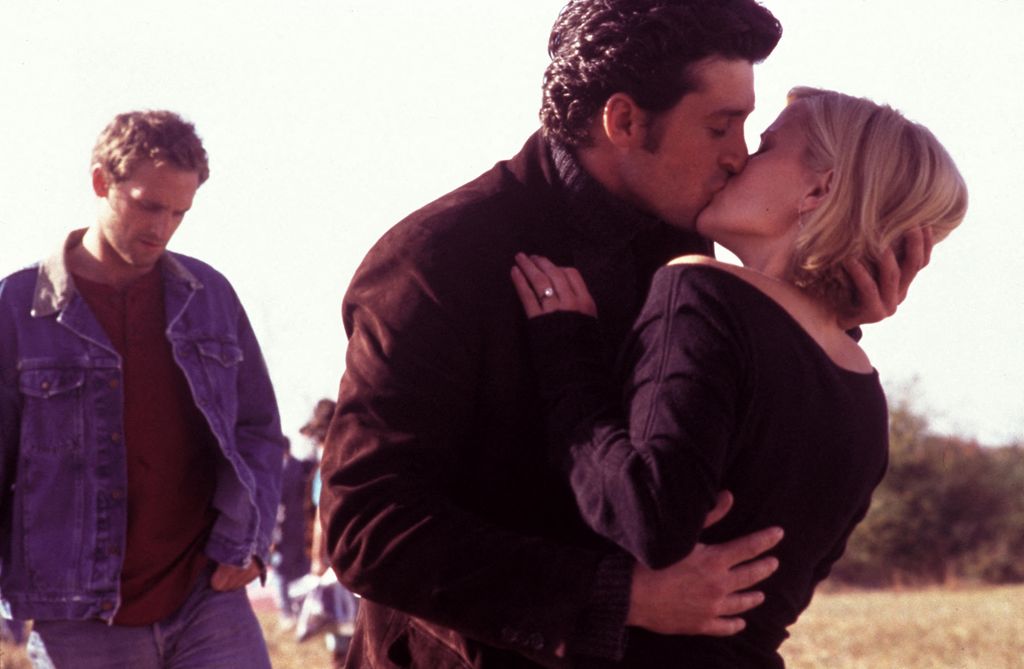 Patrick Dempsey kissing Reese Witherspoon as Josh Lucas looks on in a still image from Sweet Home Alabama