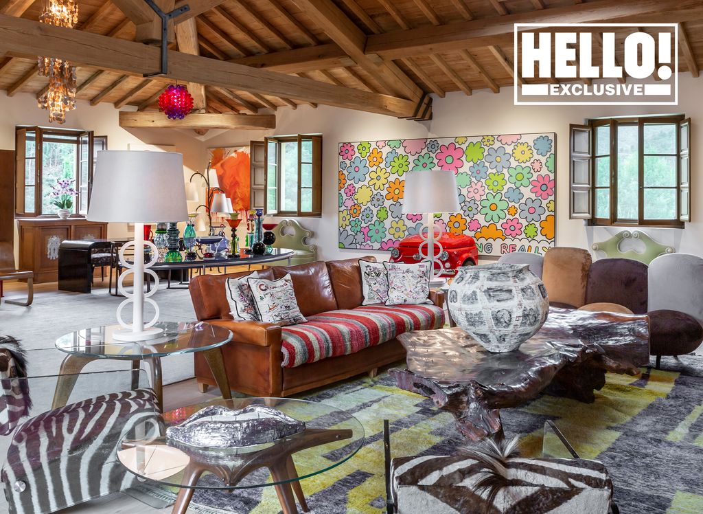 Suzanne Syz living room with exposed beams brown leather sofa and colour clashing prints