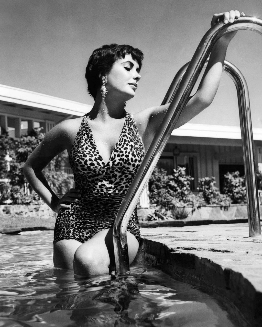 Elizabeth Taylor in 1955 emerging from a swimming pool