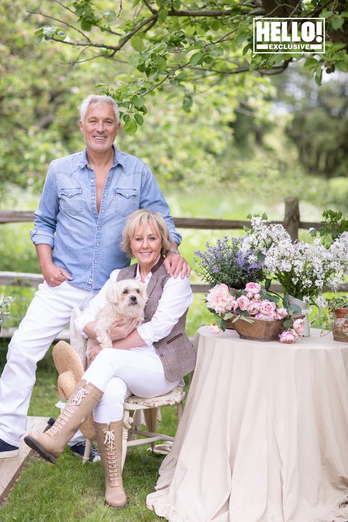 Shirlie Kemp poses with their dog and husband Martin as they sit in her garden