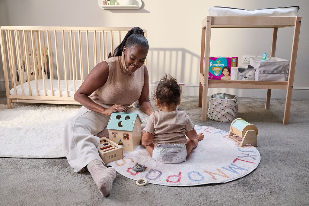 mother playing with baby daughter