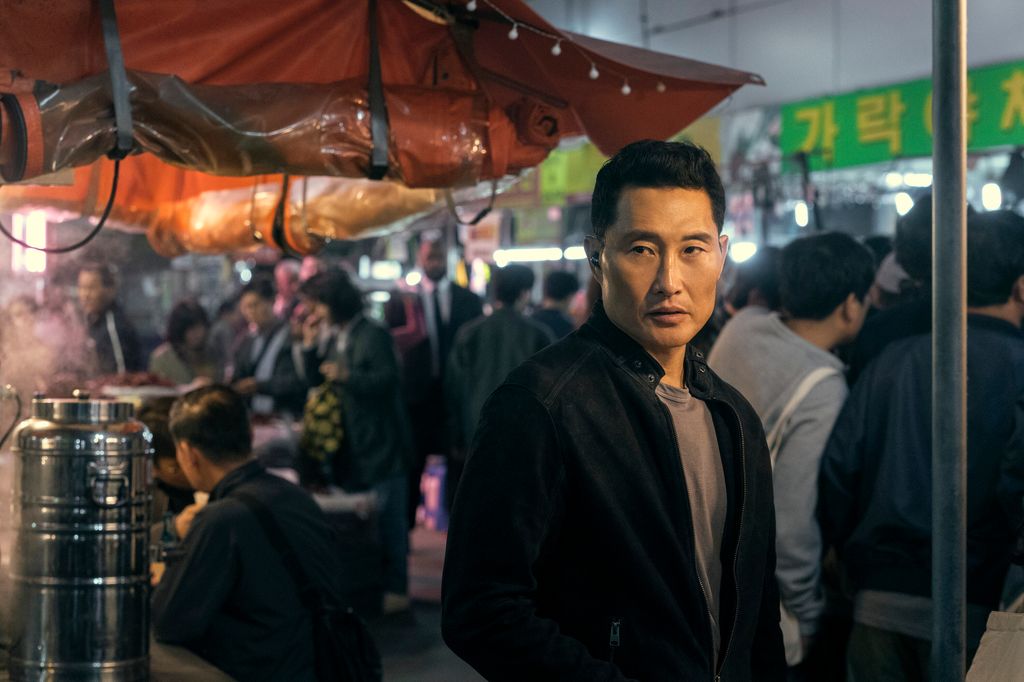 man standing in busy market