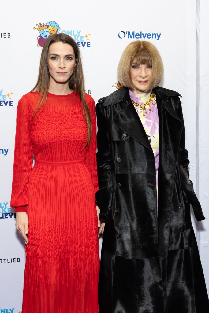 Anna Wintour in black coat with her daughter Bee Carrozzinia in red dress