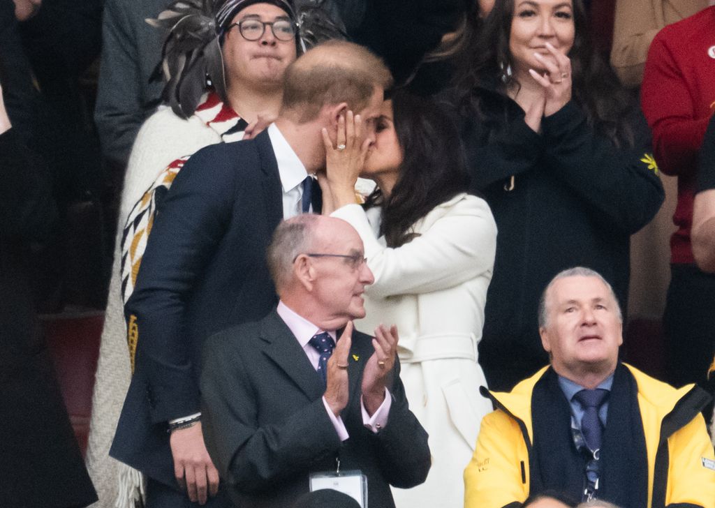 Prince Harry, Duke of Sussex and Meghan, Duchess of Sussex kiss during the opening ceremony of the 2025 Invictus Games