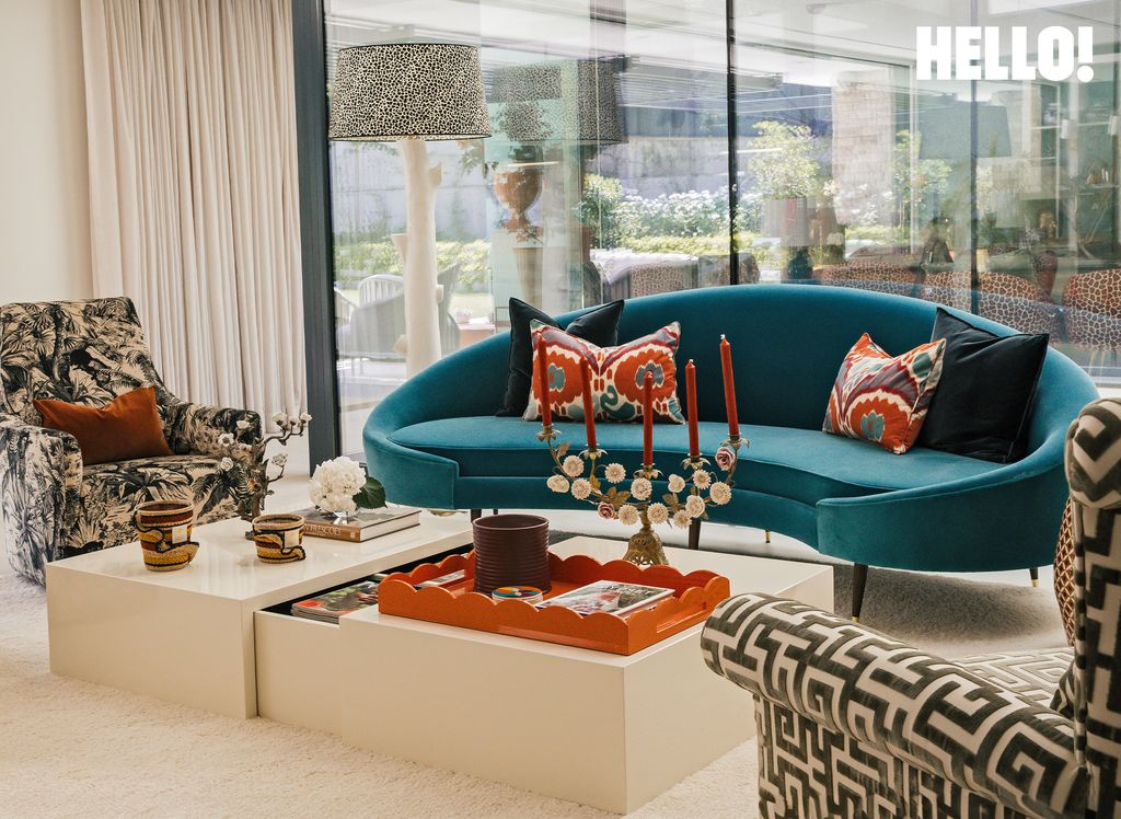 One of the furnished living rooms with an orange and blue theme inside their three-storey, contemporary-style house