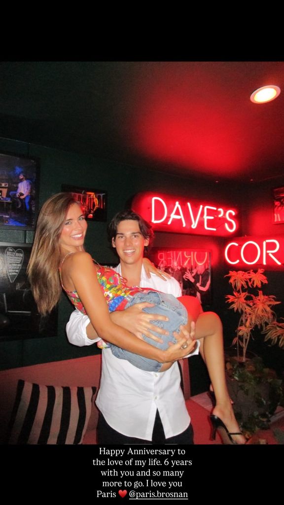Paris Brosnan carrying his girlfriend in bar
