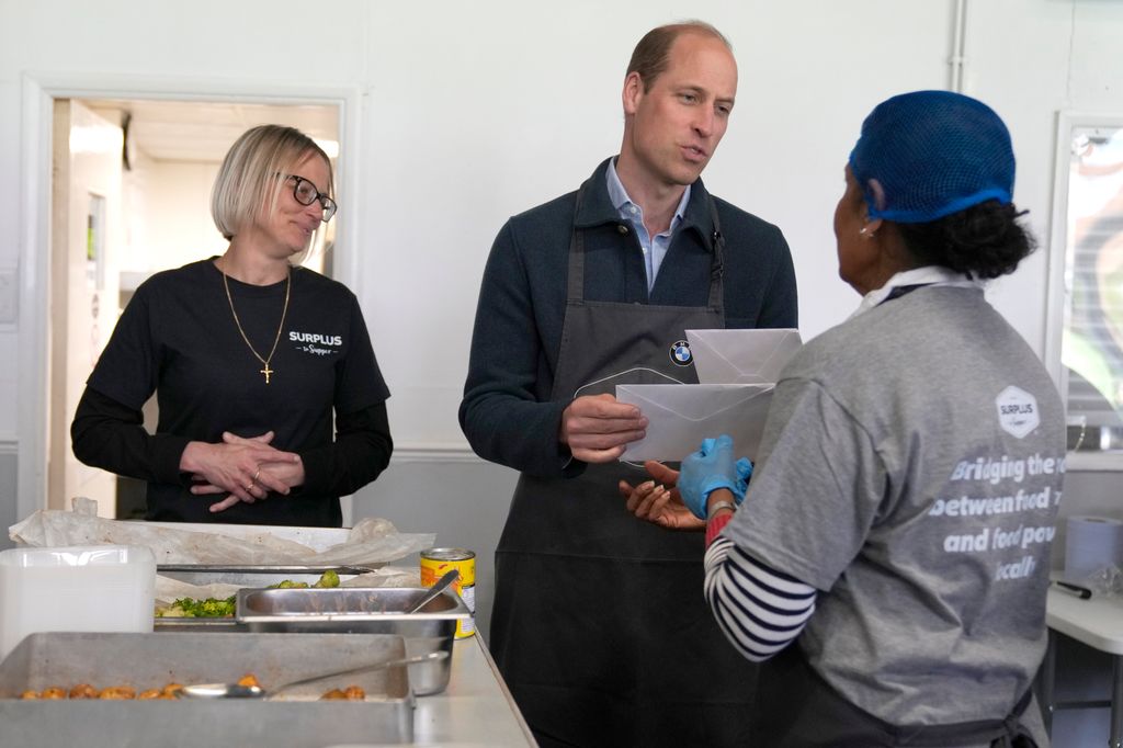 The Prince accepts a get-well card for his wife when visiting a food distribution charity in April this year