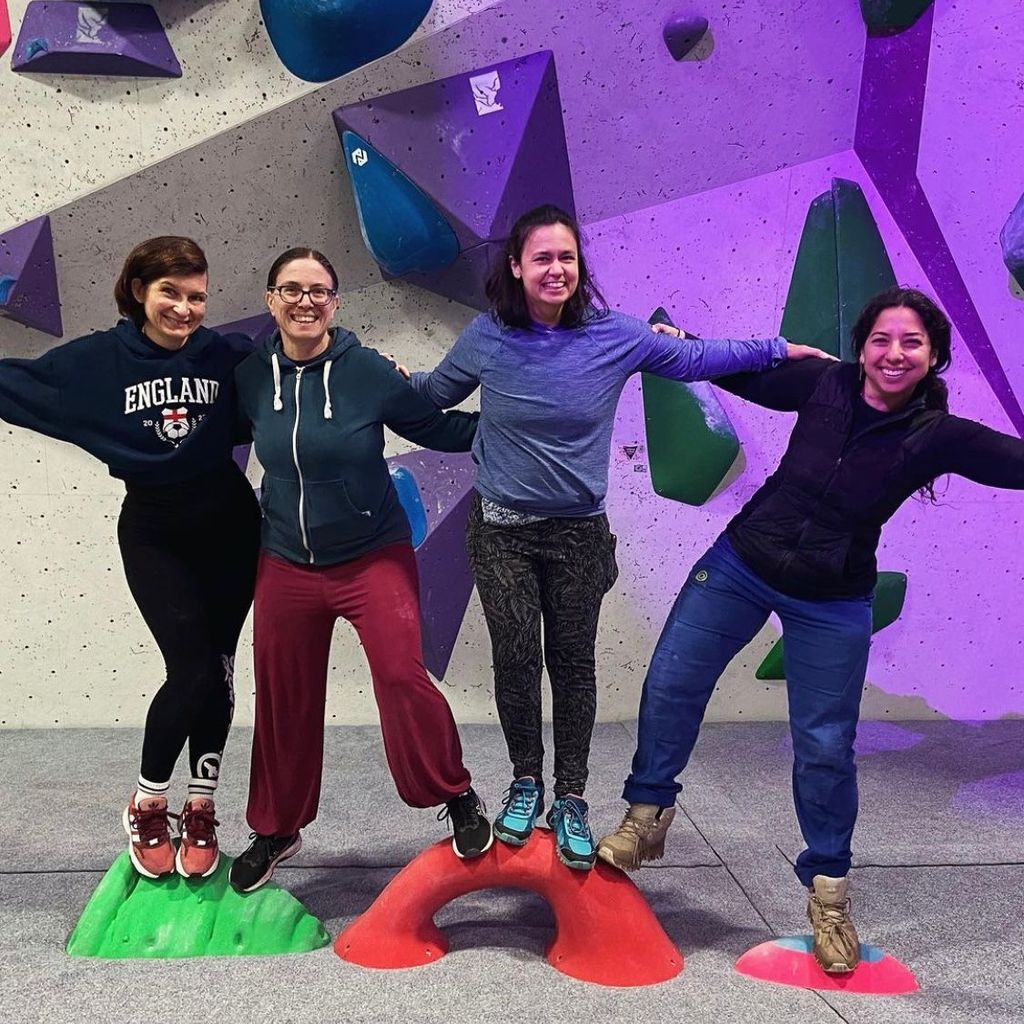 Group of four women at a climbing wall