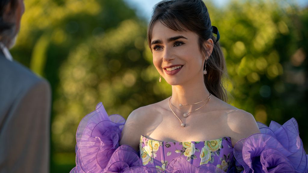 Emily Cooper (Lilly Collins) wearing a purple dress. 