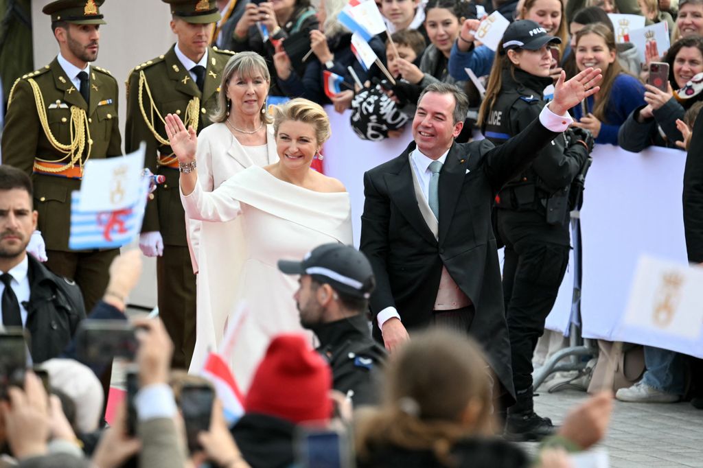 Grand Duke Guillaume  and Duchess Stephanie wave to the crowd as they arrive for a solemn session in front of the City Hall 
