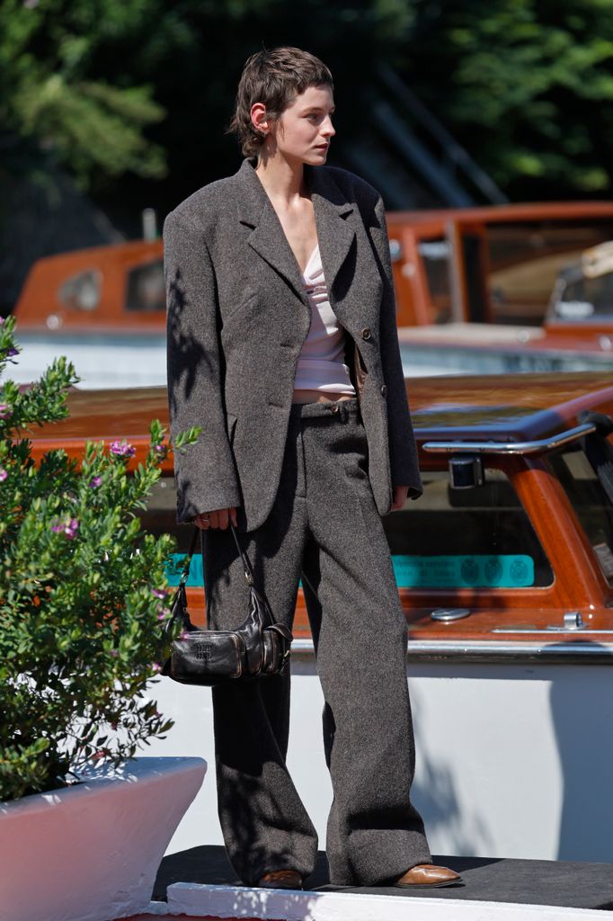 Emma Corrin was seen at Hotel Excelsior during the 82nd Venice International Film Festival in grey suit