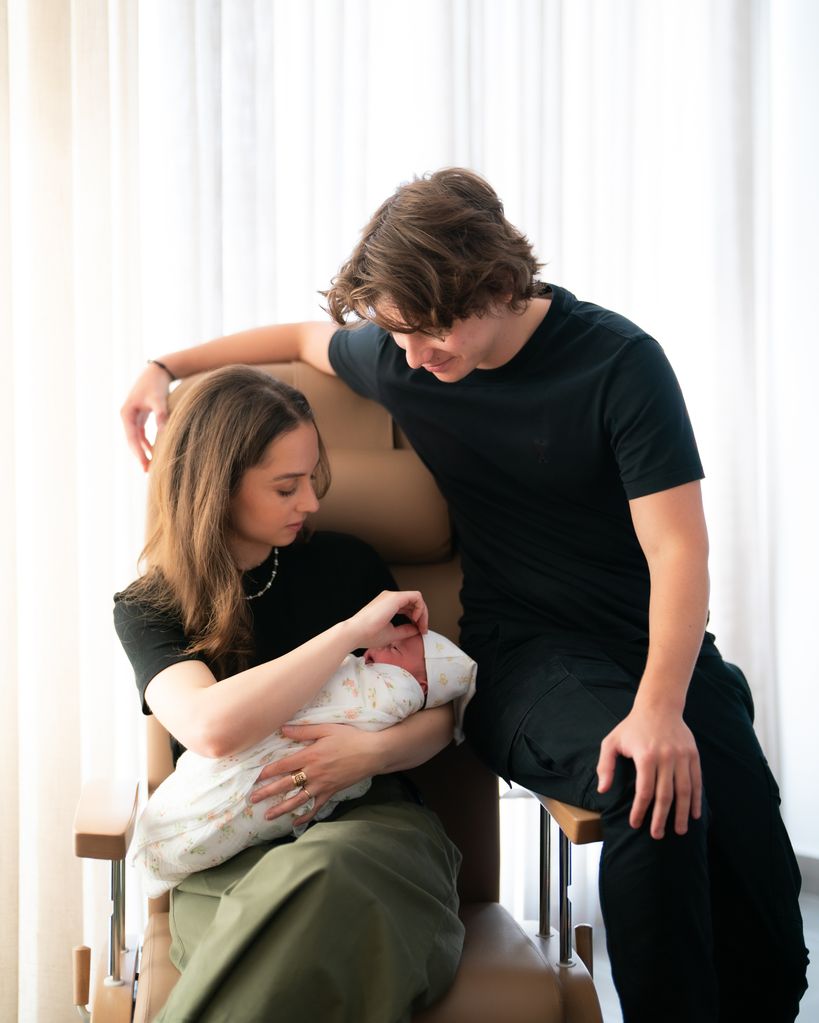 Princess Salma carrying a baby girl with Prince Hashem sat with them