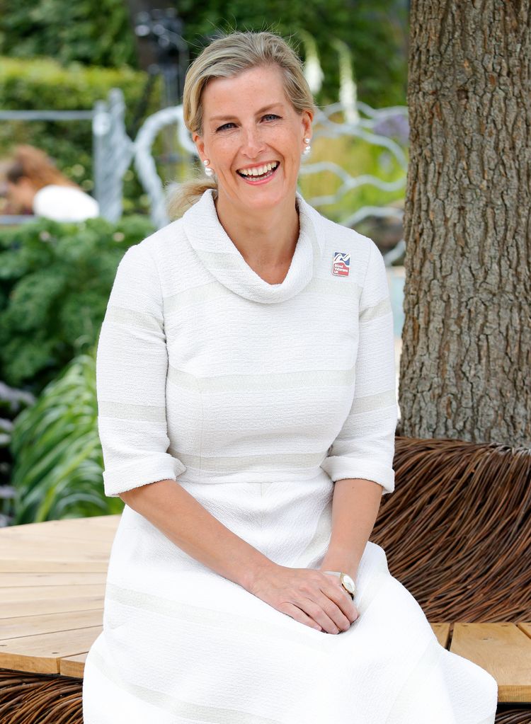 The Duchess of Edinburgh wearing a white dress and smiling at Hampton Court Flower Show