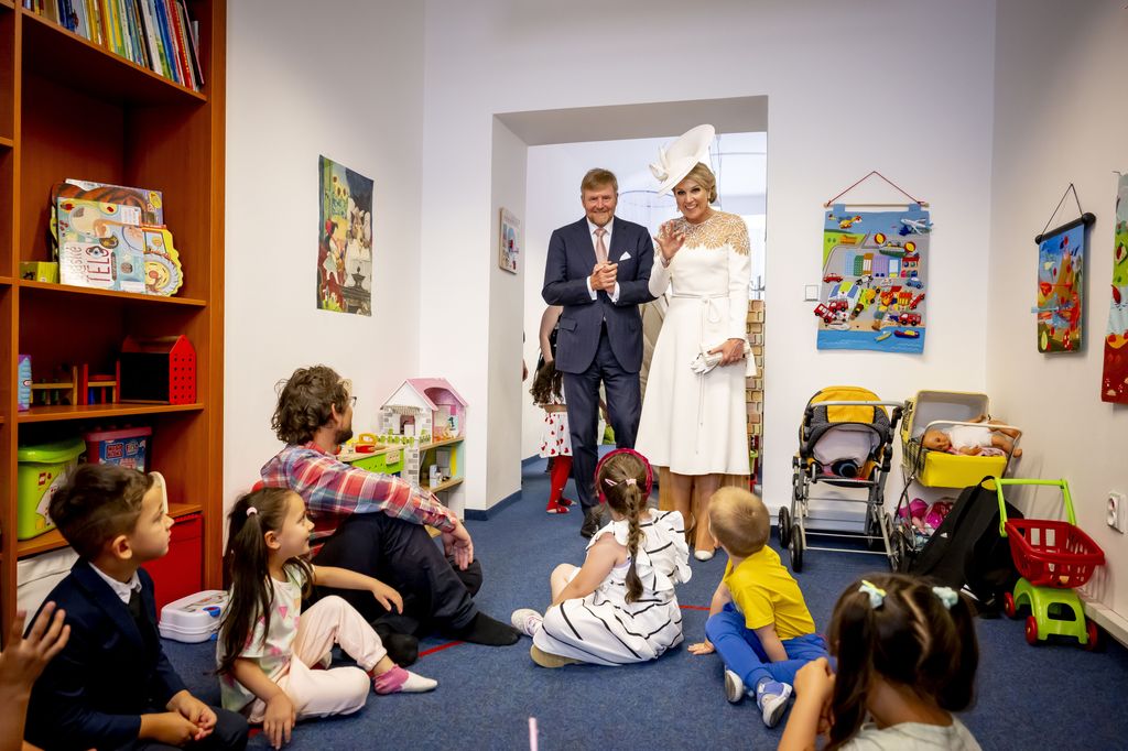 King Willem Alexander and Queen Maxima wave at children at People in Need