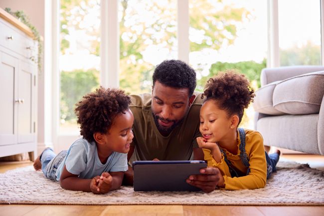 father with children on ipad