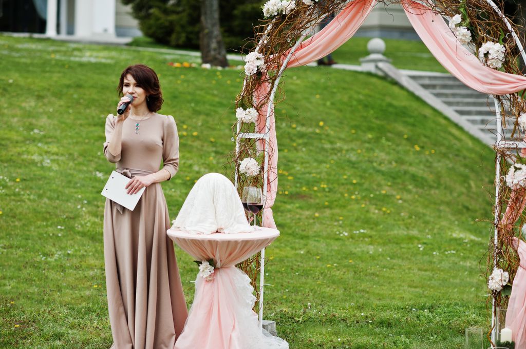 A woman reading at a wedding ceremony