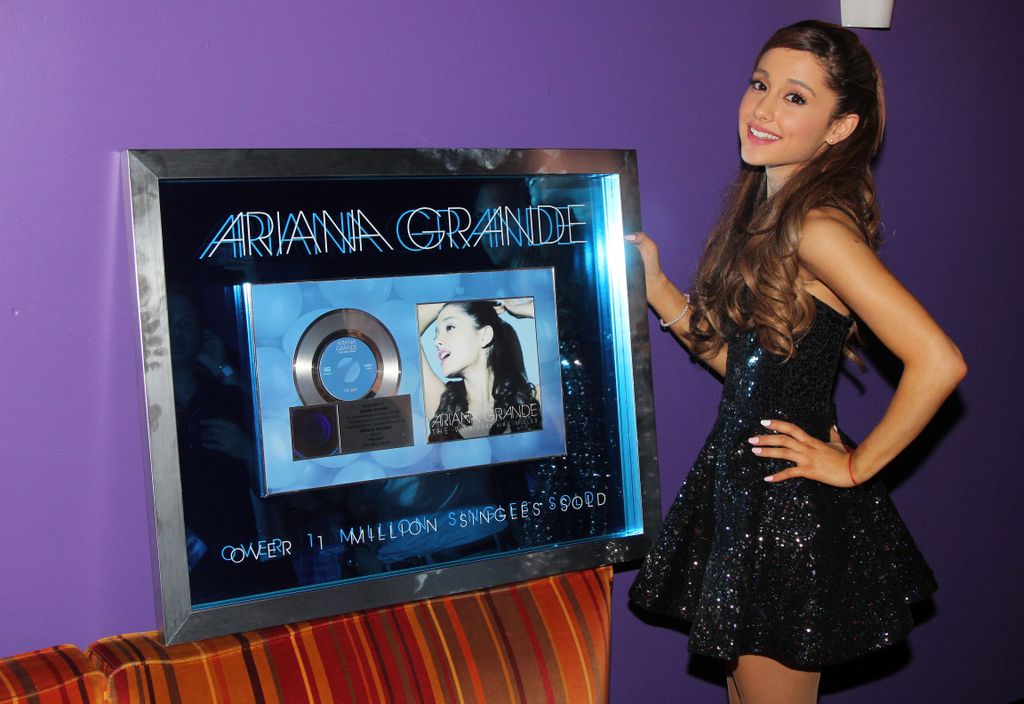 Ariana with her Yours Truly platinum album