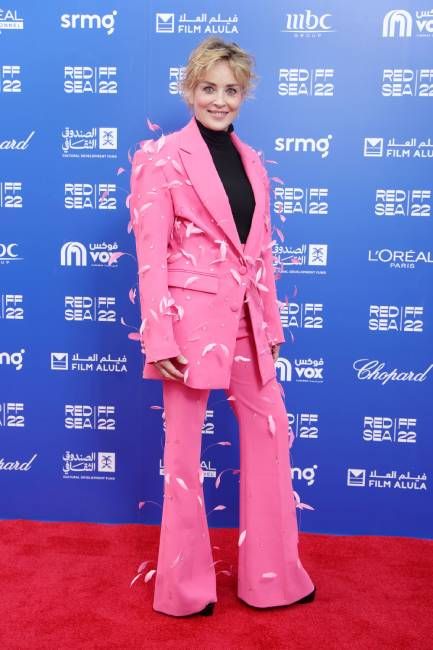 Sharon Stone walks the red carpet in a pink suit at the Red Sea International Film Festival