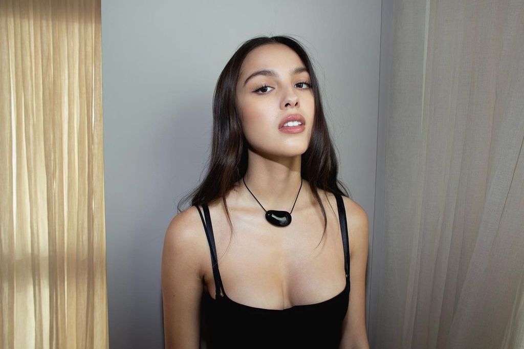 Olivia Rodrigo wearing black statement necklace and mini dress