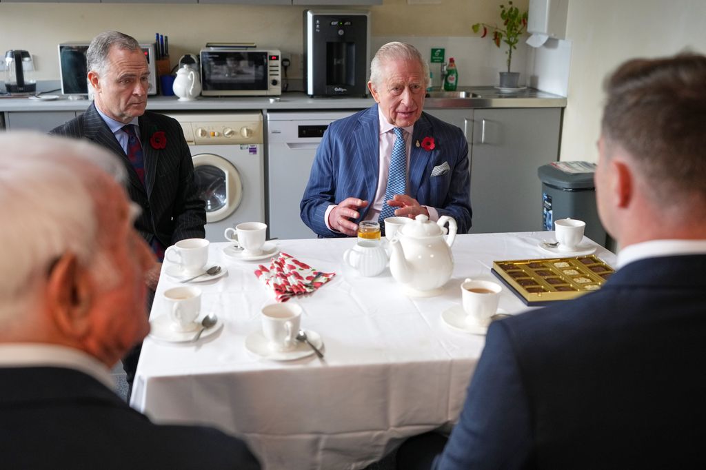King Charles sits beside Shane Barker as he visits Chatfield Health Care to find out more about the services and bespoke support they provide to veterans