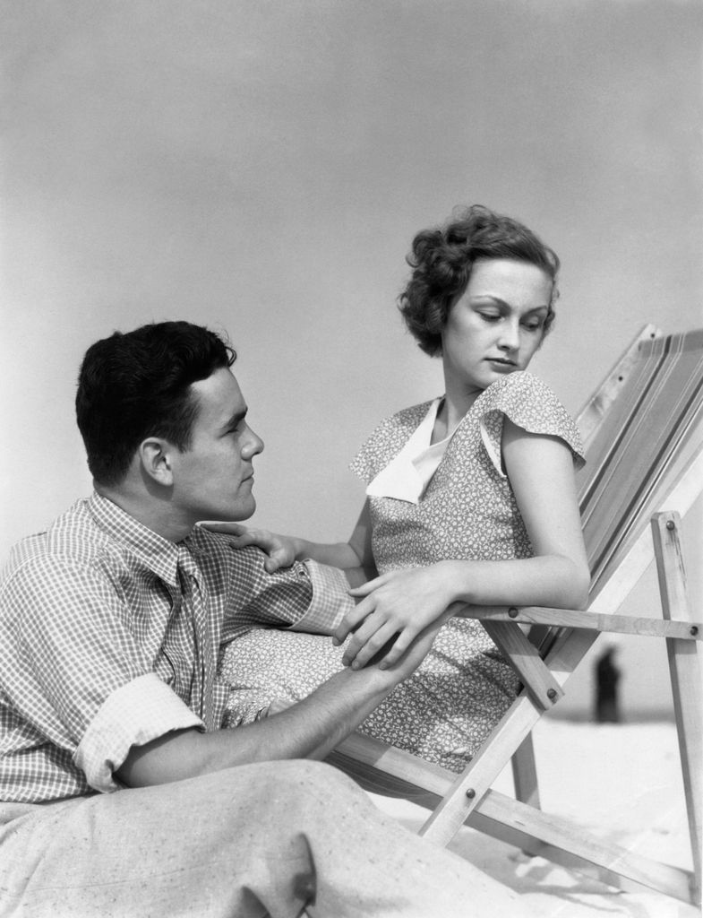 1930s COUPLE LOVERS QUARREL WOMAN BEACH CHAIR HEAD TURNED AWAY FROM MAN SITTING BESIDE HER (Photo by H. Armstrong Roberts/ClassicStock/Getty Images)