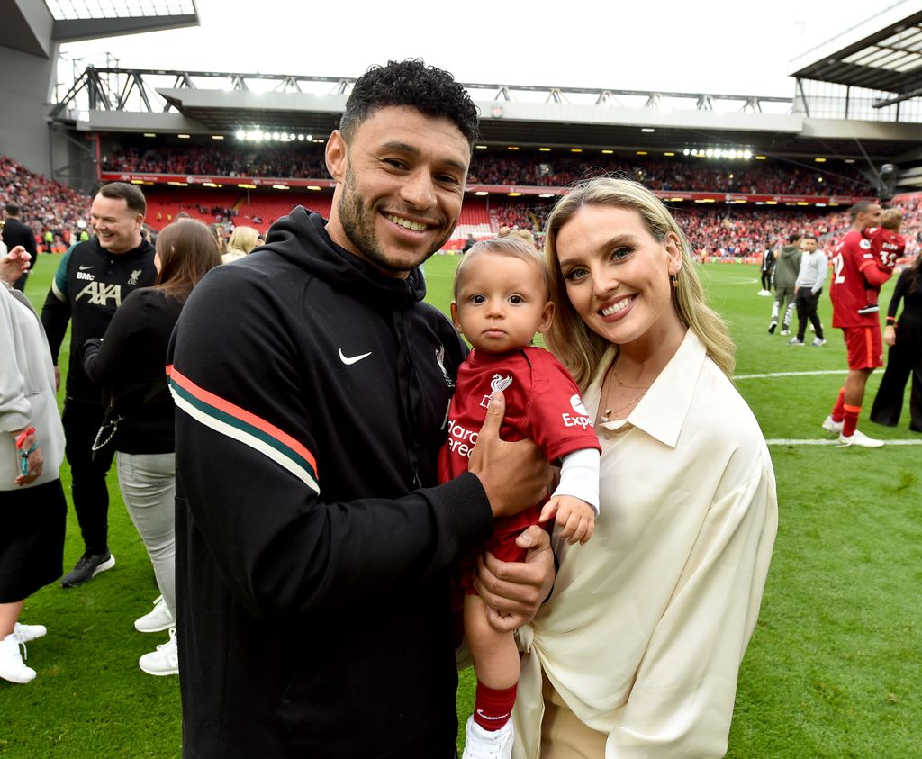Alex, perrie and axel posing for a photo after a football game